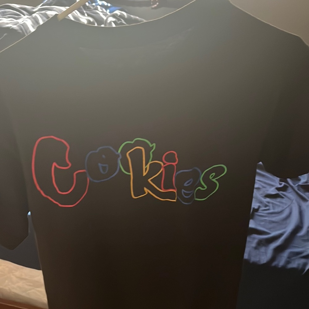 Black cookies shirt and a multi color logo